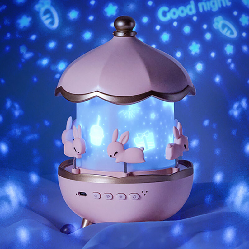 Veilleuse avec projecteur d'étoiles rotatif avec haut-parleur Bluetooth. Bonne qualité, et à la mode de couleurs rose.