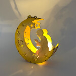 Veilleuse coranique en forme de lune à LED avec un enfant priant, allumée avec des reflets sur un mur blanc